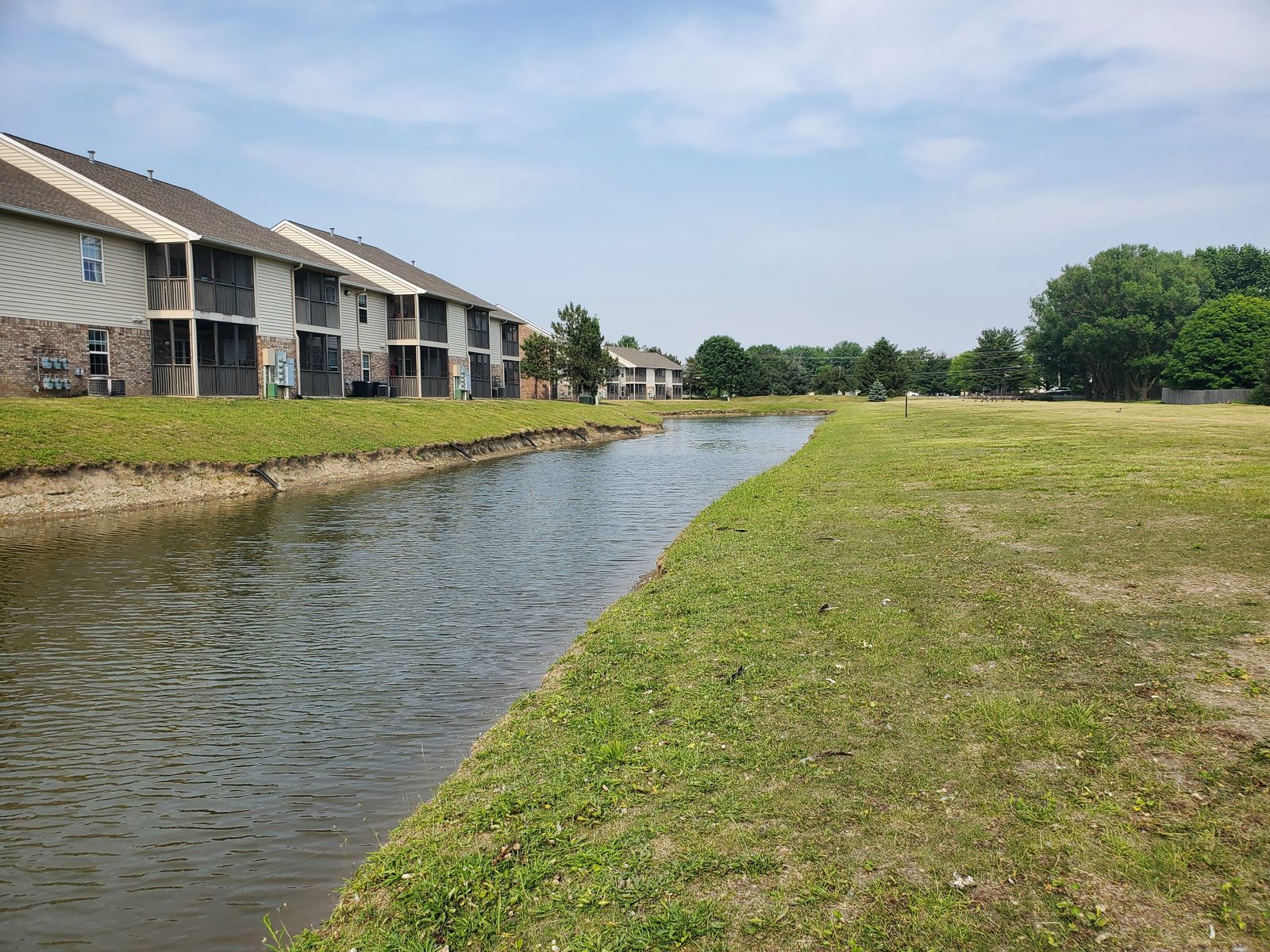 Before: Eroded pond shoreline prior to remediation