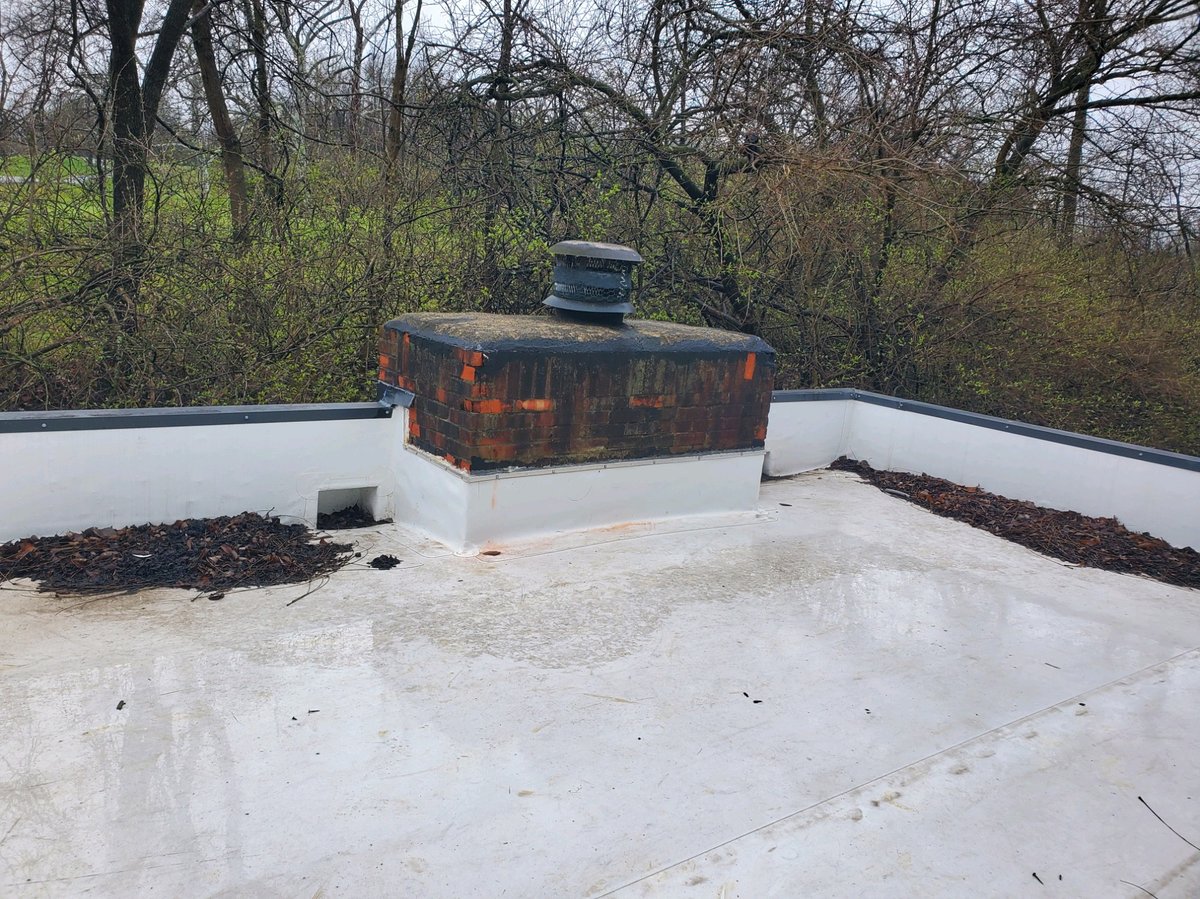 New flat roof with white membrane coating installed