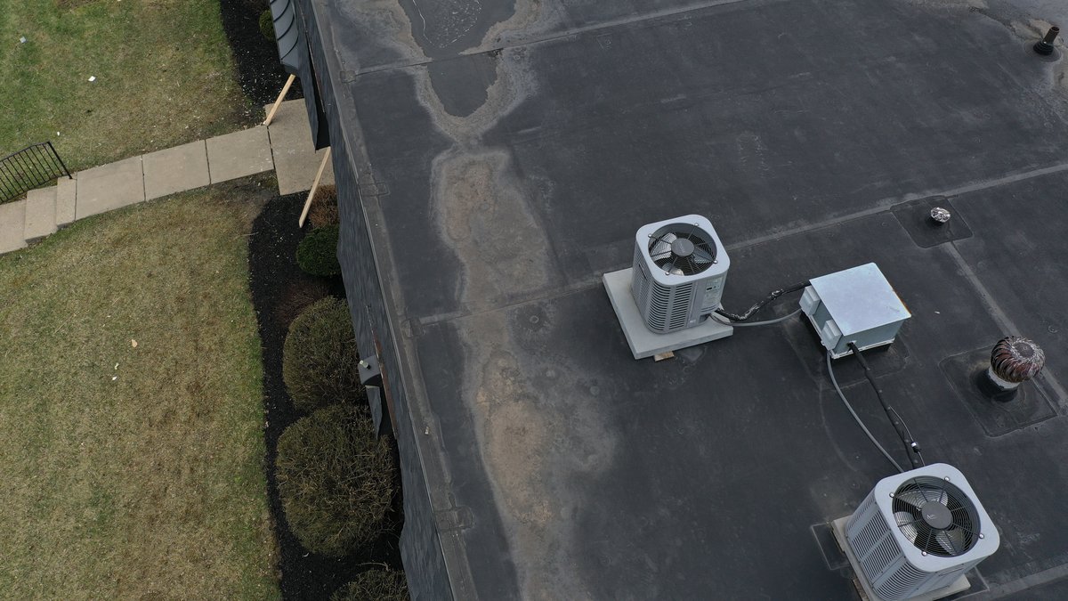 Drone view of new shingle roof and HVAC units