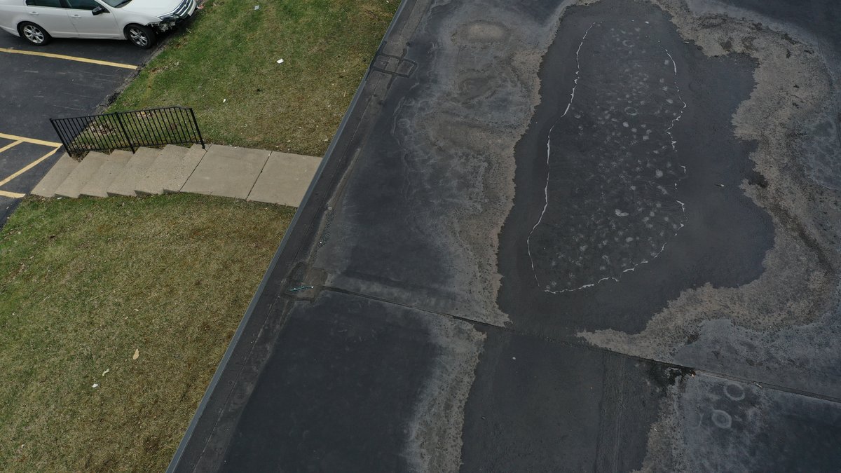 Drone view of building corner with new shingles