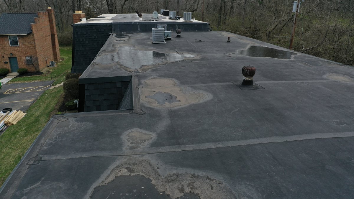 Drone view of flat roof section during repair work