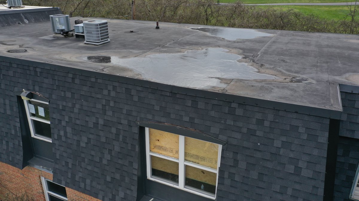 Drone view of building exterior and landscaping